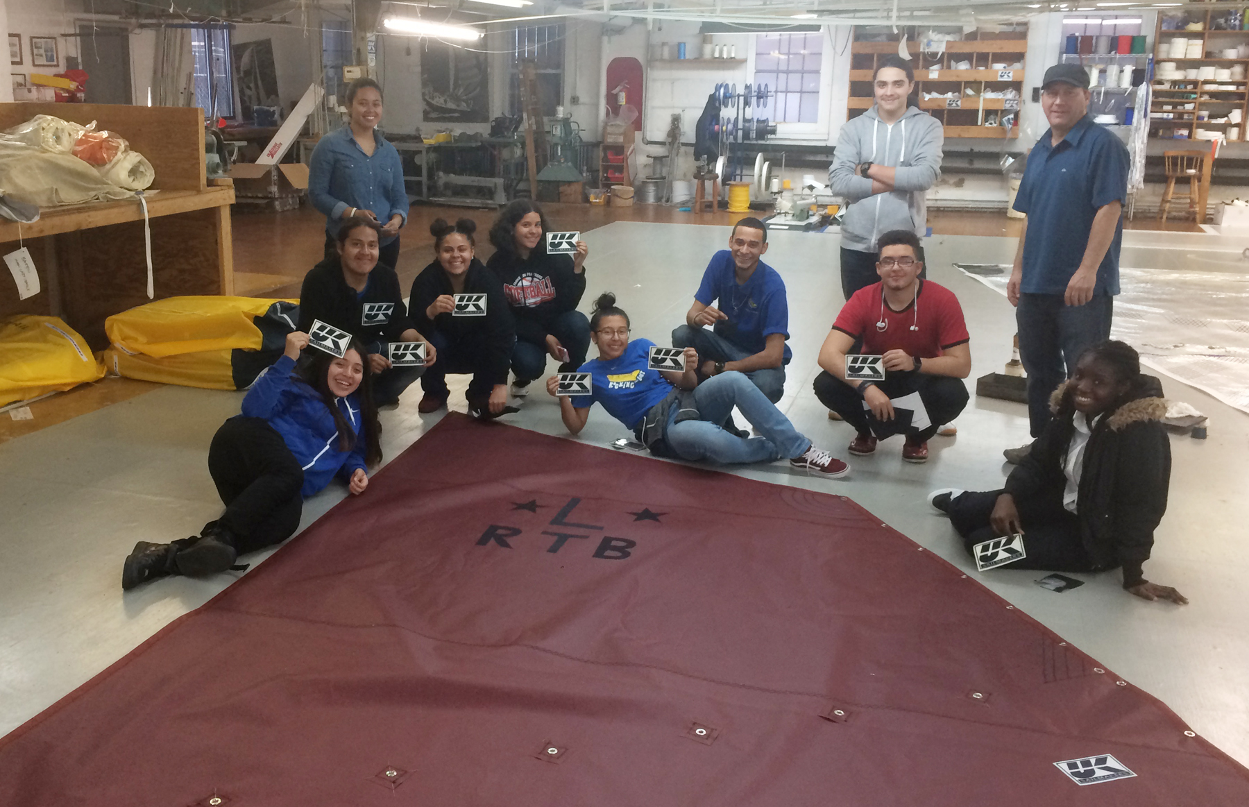 Future sailmakers proudly posing with their finished product.