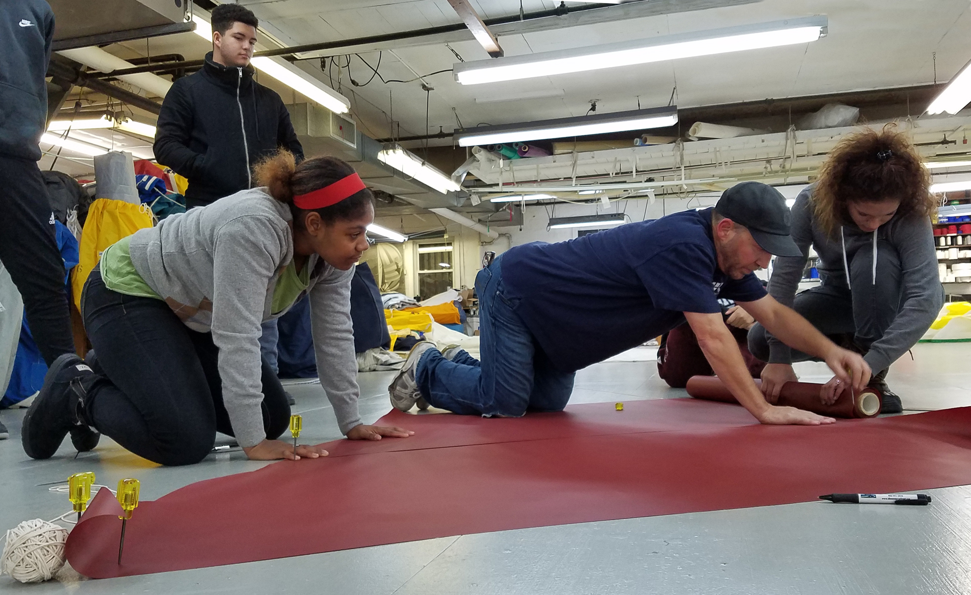 Students learning the art of sailmaking.