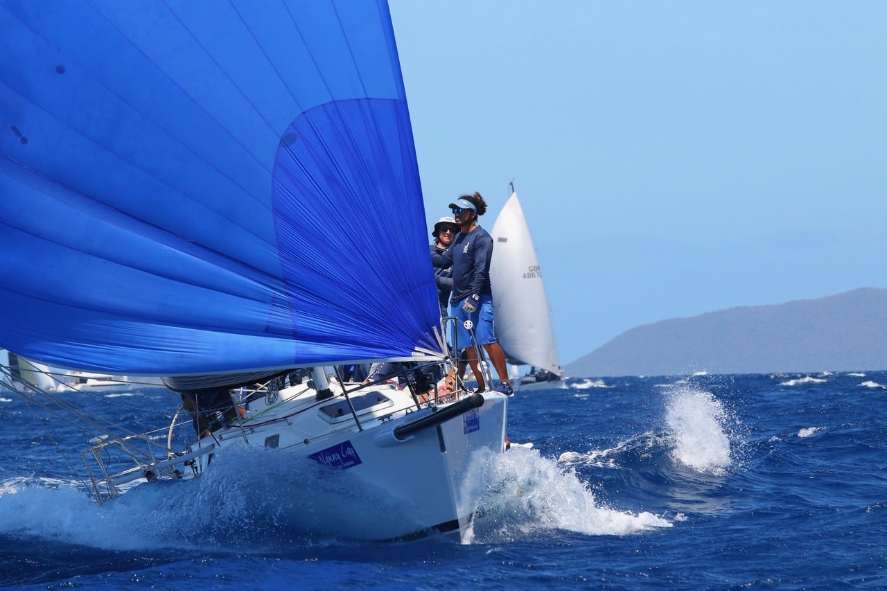 J/105 JENK sailing downwind with a large blue asymmetrical spinnaker.