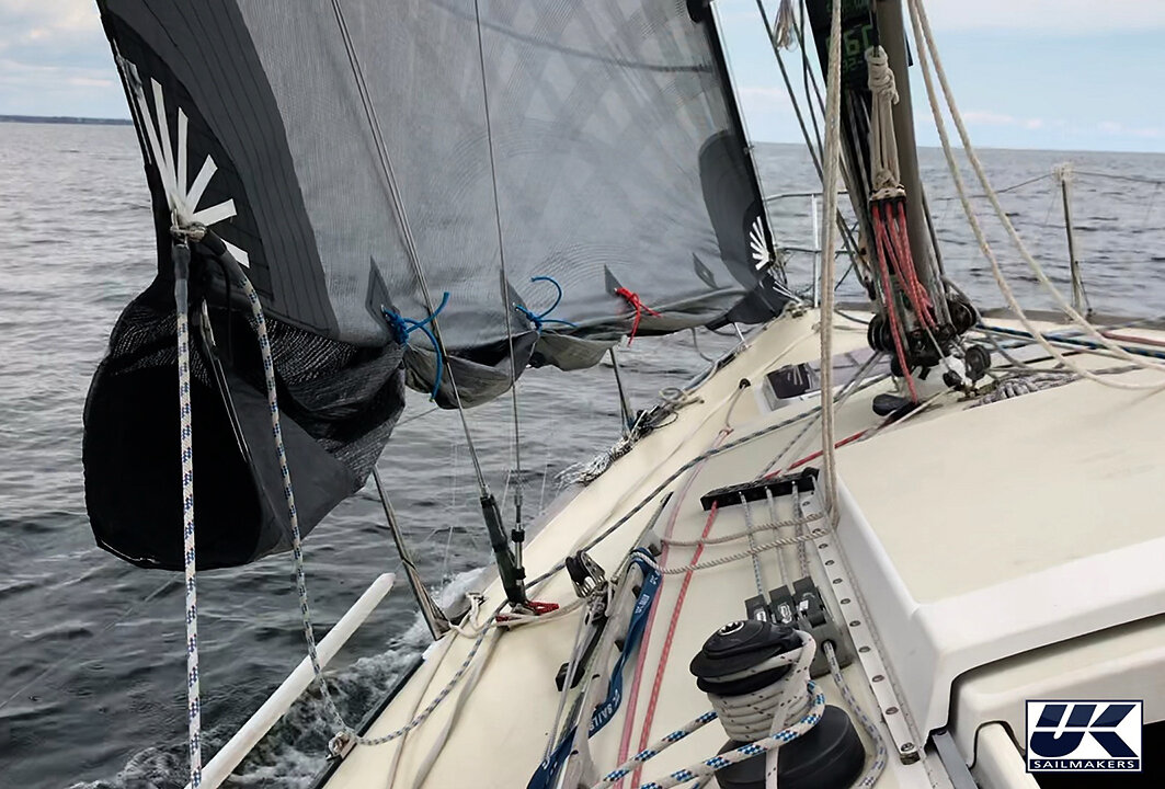 Above: The reefed part of the sail is shown tied up. Below: The reefed part is rolled and then zipped away with an integral zipper system.